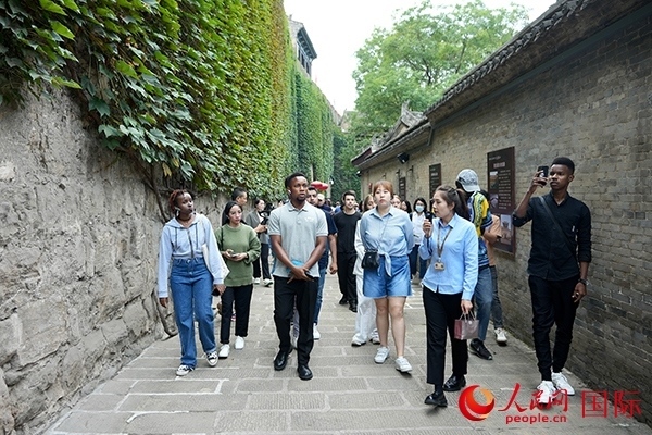 選手們認(rèn)真聆聽(tīng)導(dǎo)游講解。人民網(wǎng) 盧鵬宇攝