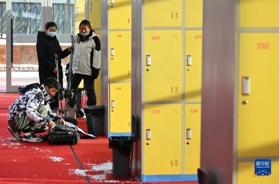 12月21日，游客在滑雪服務(wù)大廳整理滑雪裝備。