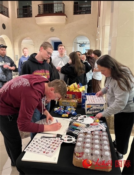 學生們出發(fā)前紛紛在留言簿留言。人民網(wǎng)記者 鄧圩攝