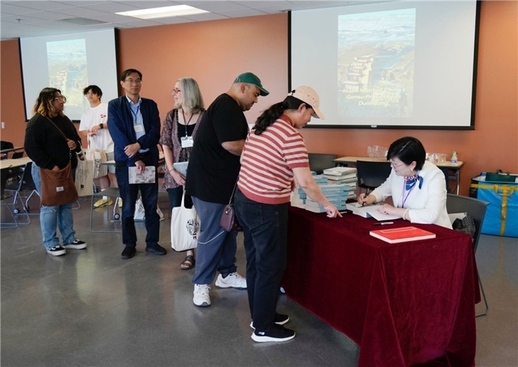 作者顧春芳在活動(dòng)現(xiàn)場(chǎng)簽名贈(zèng)書。羅先勇攝