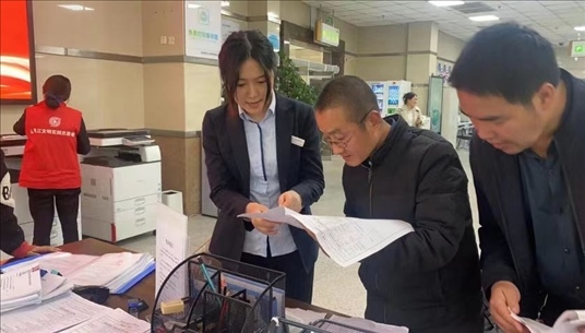 四川省成都市溫江區(qū)市場(chǎng)監(jiān)管局工作人員為群眾提供幫辦服務(wù)。圖片來(lái)源：人民網(wǎng)四川頻道