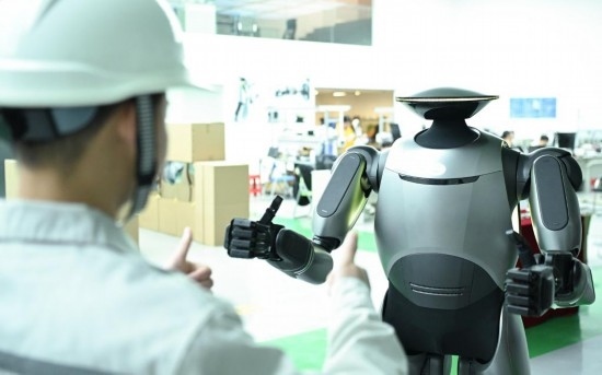 在廣汽研究院，人形機器人團隊的周仁義在演示GoMate機器人互動功能（新華社記者 鄧華 攝）